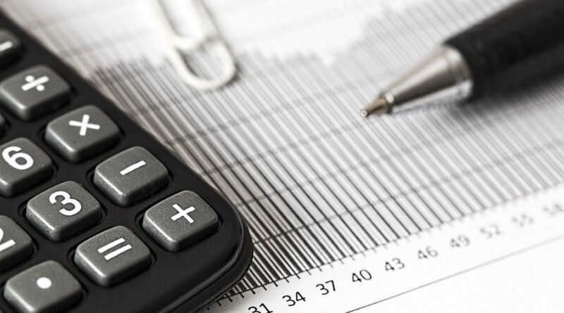 calculator and pen on table